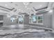Expansive living space with marble floors, modern lighting, large windows, and glass sliding doors at 534 Estuary Shore Ln, Apollo Beach, FL 33572