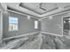 Spacious main bedroom featuring tray ceilings, recessed lighting, and gray walls at 534 Estuary Shore Ln, Apollo Beach, FL 33572