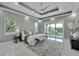Bright main bedroom with sliding doors to balcony and marble floors at 548 Estuary Shore Ln, Apollo Beach, FL 33572