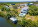 Waterfront property featuring a two-story home with pool and private dock at 548 Estuary Shore Ln, Apollo Beach, FL 33572