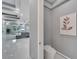 Chic powder room with contemporary toilet and elegant wall art at 548 Estuary Shore Ln, Apollo Beach, FL 33572
