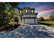 Stunning two-story home with a gray and white color scheme, and a paved driveway at 548 Estuary Shore Ln, Apollo Beach, FL 33572