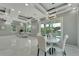 Bright dining area with white table and chairs, access to patio at 548 Estuary Shore Ln, Apollo Beach, FL 33572