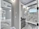 Modern bathroom with gray vanity and marble shower at 534 Estuary Shore Ln, Apollo Beach, FL 33572