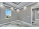 Spacious bedroom featuring gray walls and a window with natural light at 534 Estuary Shore Ln, Apollo Beach, FL 33572