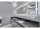 Bathroom with double vanity and modern black countertop at 534 Estuary Shore Ln, Apollo Beach, FL 33572