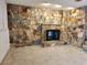 Stone fireplace with modern black insert at 2275 Willowbrook Dr, Clearwater, FL 33764