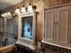 Bathroom features granite countertop, decorative mirror and built-in storage at 2275 Willowbrook Dr, Clearwater, FL 33764