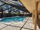 Inviting screened pool area with a kidney-shaped pool and brick pavers at 2275 Willowbrook Dr, Clearwater, FL 33764