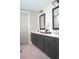 Bathroom featuring double sinks with gray cabinets, white quartz countertops, and modern fixtures at 213 W Giddens Ave, Tampa, FL 33603