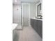 Bathroom with walk in glass shower, soaking tub, double sink vanity, and gray cabinets at 213 W Giddens Ave, Tampa, FL 33603
