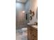 Bathroom with walk-in shower, modern vanity, and decorative accents at 213 W Giddens Ave, Tampa, FL 33603