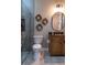 Modern bathroom featuring a glass-enclosed shower, decorative wall art, and a wood vanity at 213 W Giddens Ave, Tampa, FL 33603