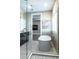 Bright bathroom featuring a soaking tub with decorative tile, glass shower, and neutral color palette at 213 W Giddens Ave, Tampa, FL 33603