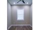 Small bedroom with window and hardwood floors at 213 W Giddens Ave, Tampa, FL 33603