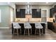 Modern kitchen with dark cabinetry, quartz countertops, and an island with seating at 213 W Giddens Ave, Tampa, FL 33603