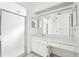 Bathroom with white vanity, a shower, and a large mirror at 1830 E Del Webb Blvd, Sun City Center, FL 33573