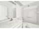 Clean bathroom with white vanity, a bathtub, and a large mirror at 1830 E Del Webb Blvd, Sun City Center, FL 33573