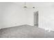 Bright bedroom with grey carpet and ceiling fan at 1830 E Del Webb Blvd, Sun City Center, FL 33573
