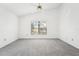 Bedroom featuring gray carpeting, a ceiling fan, and large windows at 1830 E Del Webb Blvd, Sun City Center, FL 33573