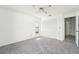 Well-lit bedroom with gray carpeting, white closet doors, and access to a bathroom at 1830 E Del Webb Blvd, Sun City Center, FL 33573
