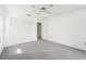 Bright bedroom with gray carpet, white walls, and a ceiling fan at 1830 E Del Webb Blvd, Sun City Center, FL 33573