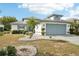 Single-story home with a two-car garage and landscaped front yard at 1830 E Del Webb Blvd, Sun City Center, FL 33573