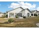 White house back with small patio and landscaping at 1830 E Del Webb Blvd, Sun City Center, FL 33573