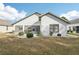 Rear view of single-story house with landscaping at 1830 E Del Webb Blvd, Sun City Center, FL 33573