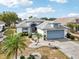 Single-story home with light blue garage door at 1830 E Del Webb Blvd, Sun City Center, FL 33573