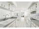 Bright kitchen features white cabinets, gray countertops, and a view to the backyard at 1830 E Del Webb Blvd, Sun City Center, FL 33573