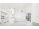 White kitchen with gray countertops and tile floors, includes breakfast bar at 1830 E Del Webb Blvd, Sun City Center, FL 33573