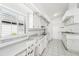 Galley style kitchen with white cabinets, gray countertops, and tile floors at 1830 E Del Webb Blvd, Sun City Center, FL 33573