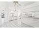 White kitchen features gray countertops and breakfast bar, with access to living areas at 1830 E Del Webb Blvd, Sun City Center, FL 33573
