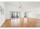 Large living room featuring laminate flooring and sliding glass doors at 1830 E Del Webb Blvd, Sun City Center, FL 33573