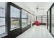 Sunroom with tiled floor, red chair, and window blinds at 1830 E Del Webb Blvd, Sun City Center, FL 33573