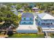 Areal shot of a home near a lake, surrounded by lush greenery and neighboring properties at 3171 Sea Grape Dr, Hernando Beach, FL 34607