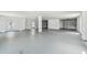 Large, unfinished basement with multiple windows and garage doors, offering potential for customization at 3171 Sea Grape Dr, Hernando Beach, FL 34607
