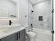 Modern bathroom with a vanity, sleek gray cabinetry, and a tiled shower with a stylish, dark showerhead at 3171 Sea Grape Dr, Hernando Beach, FL 34607