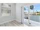 Bedroom with sliding glass doors opening to a balcony overlooking a waterfront view at 3171 Sea Grape Dr, Hernando Beach, FL 34607