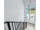 Open entryway features sleek black railings leading to a double-door entrance with transom window overlooking greenery at 3171 Sea Grape Dr, Hernando Beach, FL 34607