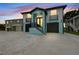 Stunning two-story home featuring a modern design, dual garages, and eye-catching blue accents at 3171 Sea Grape Dr, Hernando Beach, FL 34607