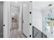 Bright hallway featuring a modern light fixture and views of a bathroom with elegant marble tiling at 3171 Sea Grape Dr, Hernando Beach, FL 34607