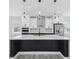 Modern kitchen featuring a large marble island with black wood accents, stainless steel appliances, and custom cabinetry at 3171 Sea Grape Dr, Hernando Beach, FL 34607