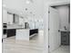 Modern kitchen featuring a marble island, stainless steel appliances, custom cabinets, and an open concept design at 3171 Sea Grape Dr, Hernando Beach, FL 34607