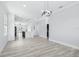 Open concept living space with wood flooring, modern lighting fixtures, and a kitchen featuring a marble island at 3171 Sea Grape Dr, Hernando Beach, FL 34607