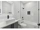 Modern bathroom featuring stylish vanity, lighted mirror, and a luxurious white marble tiled shower and tub at 3351 Fernleaf Dr, Hernando Beach, FL 34607