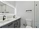 Modern bathroom featuring double sinks, vanity, and tiled shower with glass enclosure at 3351 Fernleaf Dr, Hernando Beach, FL 34607