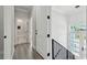 Upstairs hallway featuring a view of the bath and staircase to the first floor at 3351 Fernleaf Dr, Hernando Beach, FL 34607