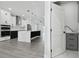 Spacious open-concept kitchen with a waterfall island, stainless steel appliances, and modern fixtures at 3351 Fernleaf Dr, Hernando Beach, FL 34607